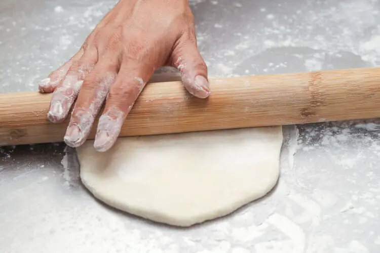 Rolling the dough with floured rolling pin