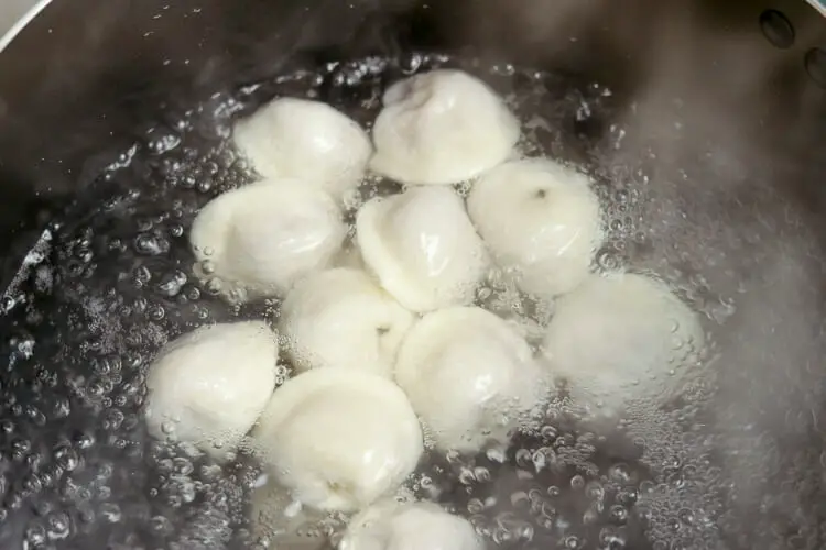Cooking dumplings in water till they rise on surface