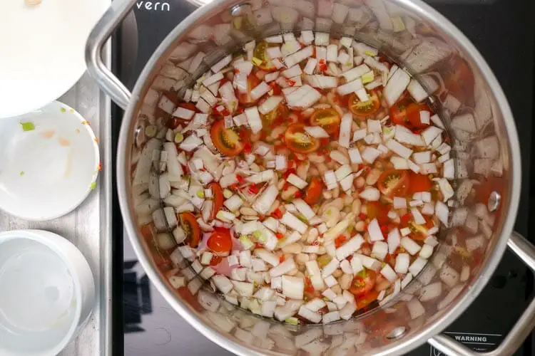 Cooking onions, pepper, garlic and tomatoes
