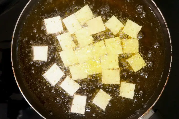 Frying tofu in the oil till little cripsy