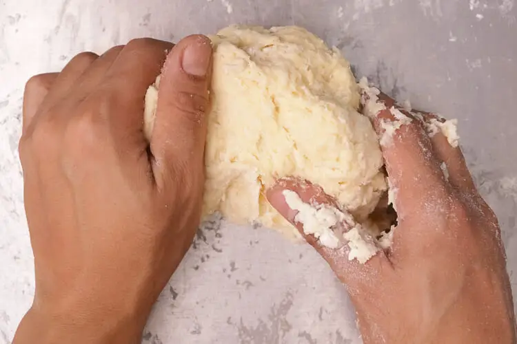 Knead pasta dough till smooth and elastic
