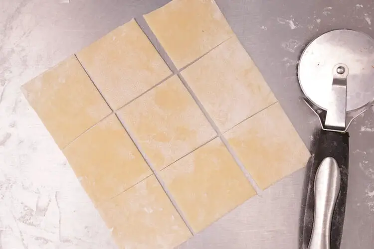 Cutting of rolled dough into tiny square pieces