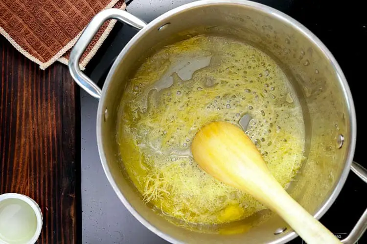 Adding butter and olive oil to deep pot