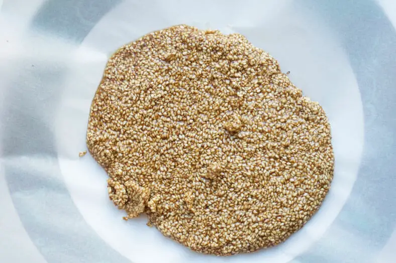 Spreading sesame mixture on flat surface