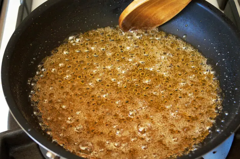 Cooking of jaggery syrup in pan till golden brown