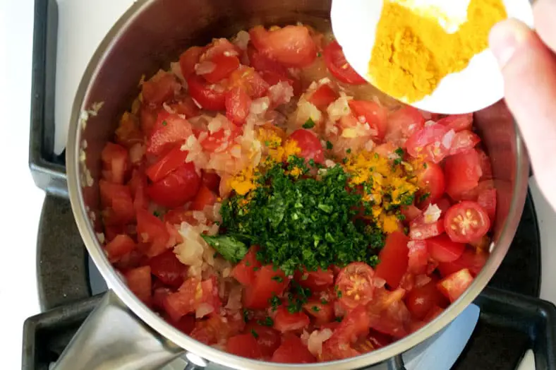 Preparing tomato curry and green mango chutney