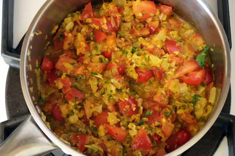 Adding spices and other vegetable in the tomato curry