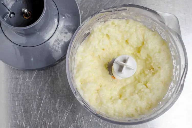 Mix white onions, garlic, ginger and oilve oil in food processor