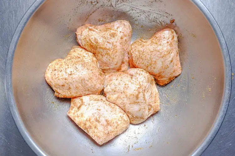 Marinating chicken with spices