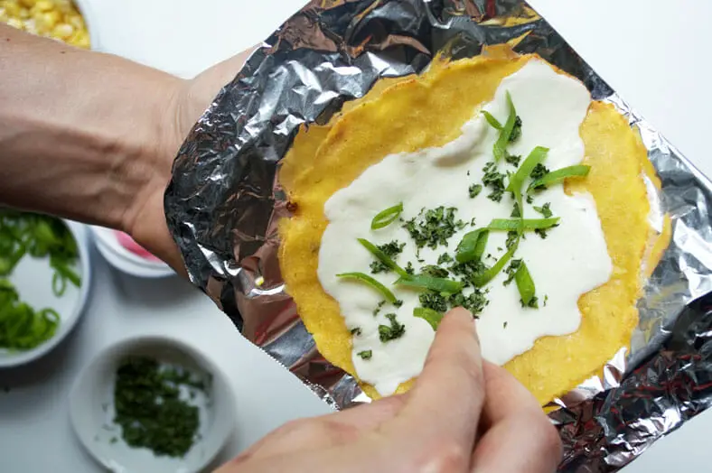 Garnishing tortilla with pickled onions, sour cream or anything of your choice