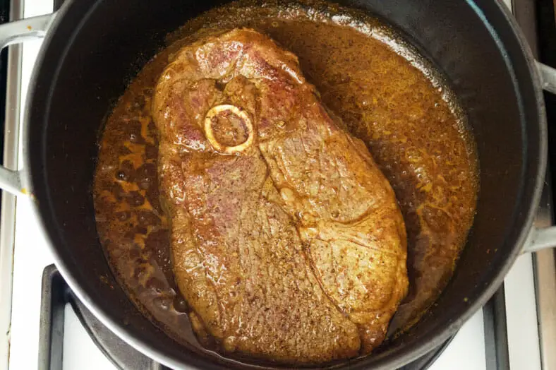 Cooking lamb with spices till it is soft