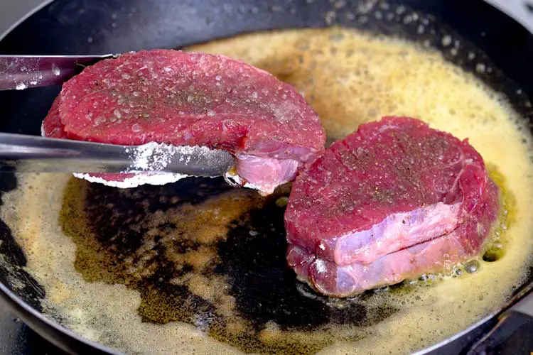 Cooking beef steak in butter