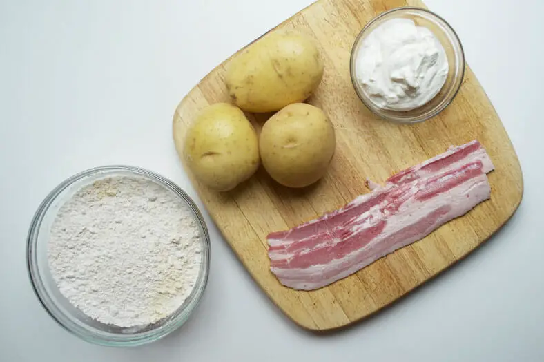 View of ingredients - potatoes, all purpose flour, cheese, bacon