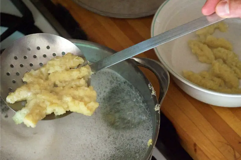 Removing cooked dumplings from boiling water