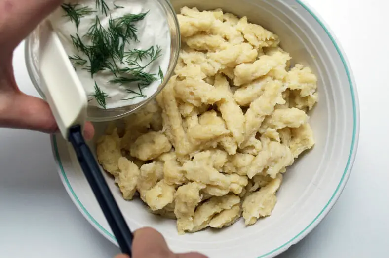 Adding chives and cheese to potato dumplings