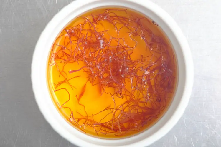 Soaking saffron threads in rose water