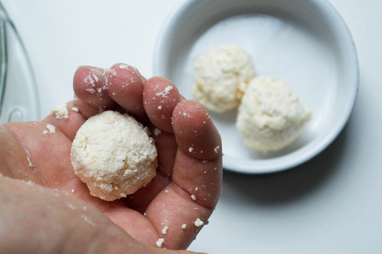 Making balls of yogurt with hands
