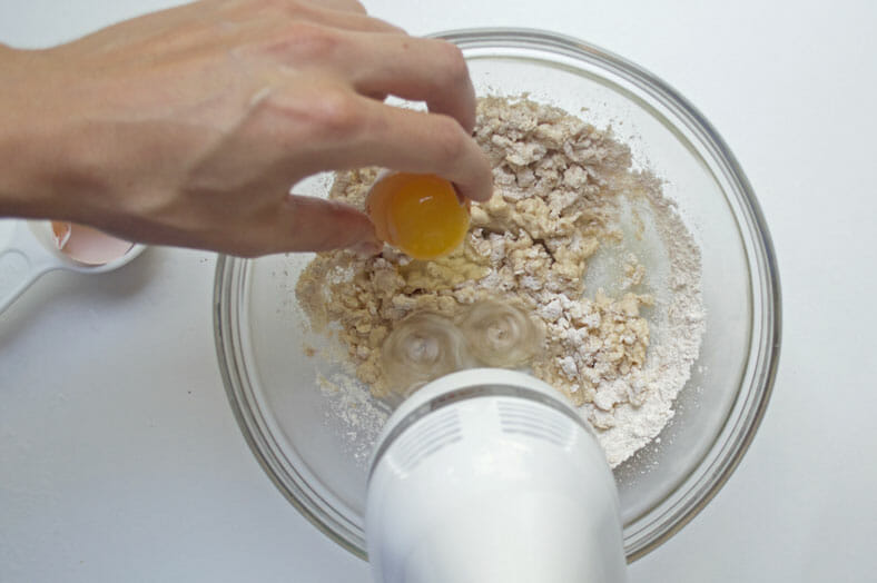 Adding egg to the mixture of flour and water