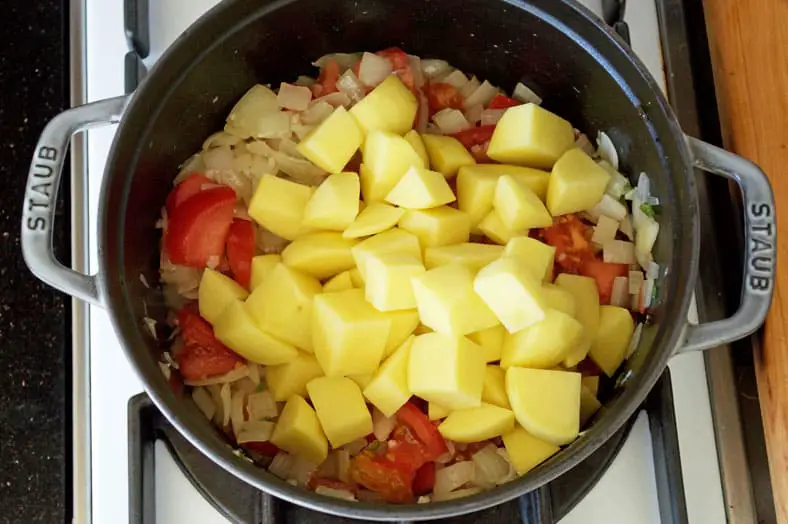 Adding potatoes in pot for cooking