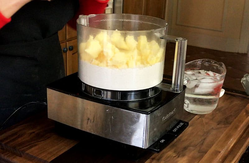 Food processor mixing butter and flour