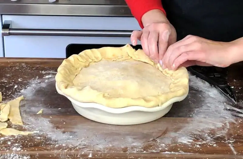 pinch and crimp two crusts together with hands