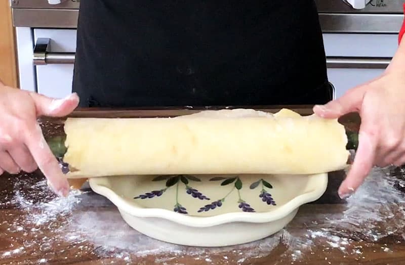 Placing bottom rolled crust in a ceramic pie plate
