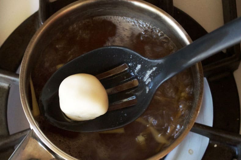Removing dumplings from ginger and sugar syrup