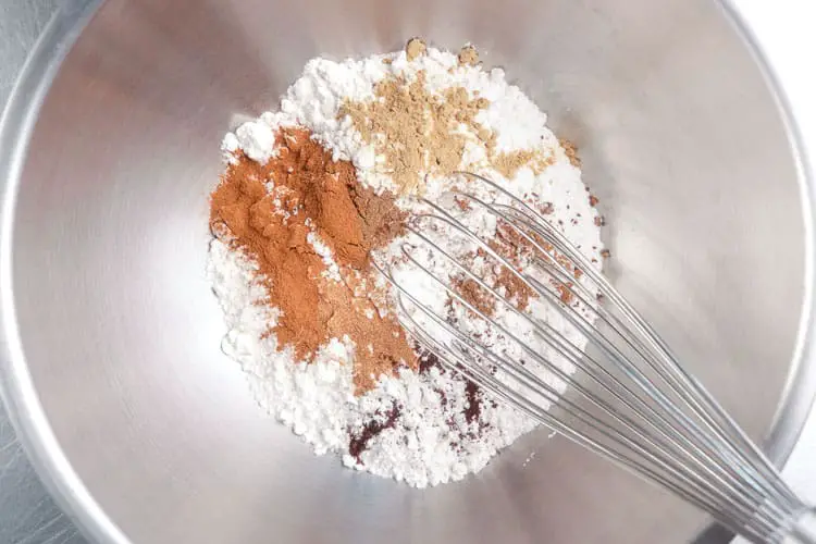 Mixing flour and spices together with whisk