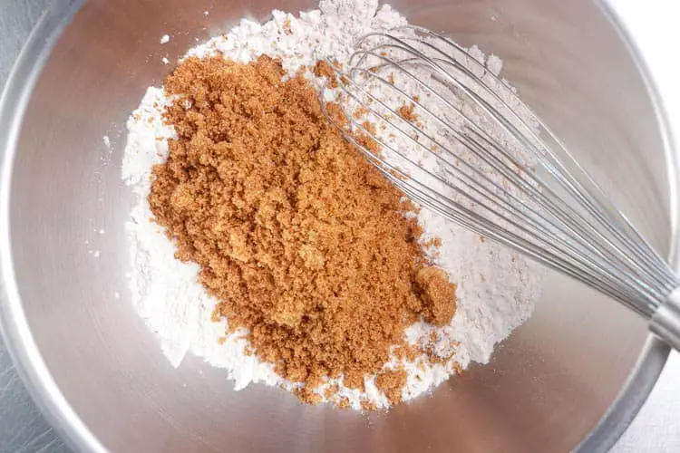 Adding sugar to flour and spices mix