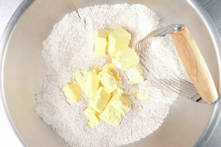 Adding butter to the flour mixture