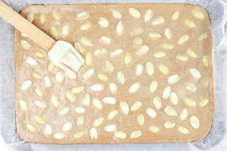 Press almond halves on the dough
