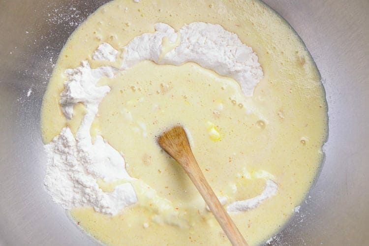 Adding sugar and salt to butter, milk and saffron cooled mix