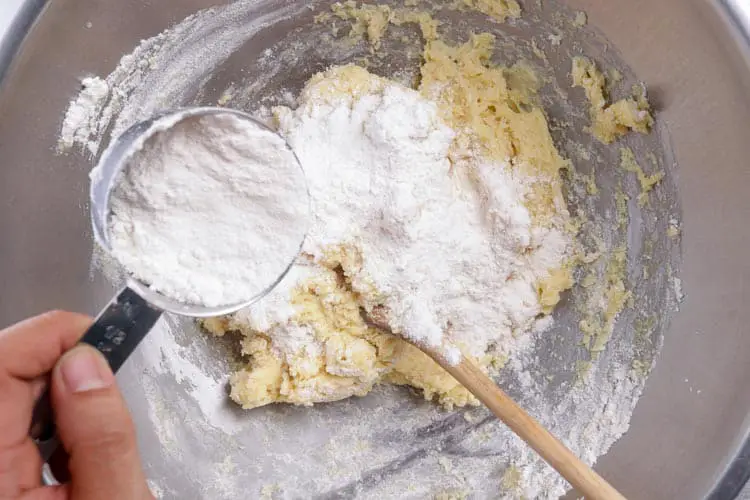 Adding flour to butter, milk and saffron cooled mix