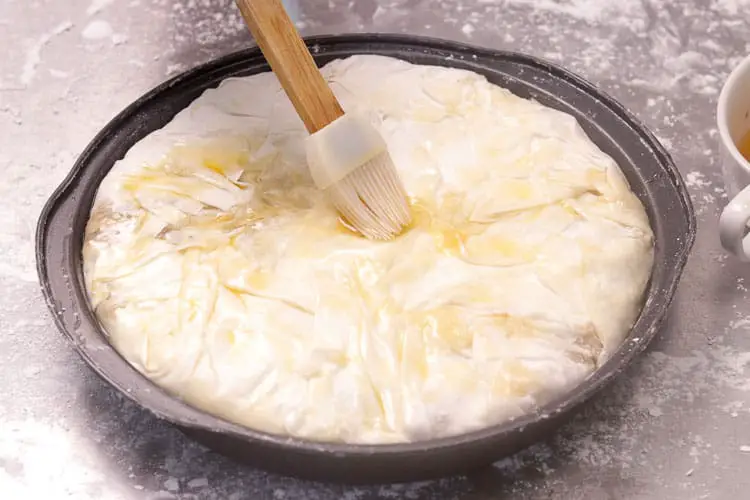 Adding oil on covered pie mix