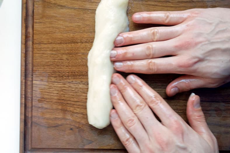 Rolling dough into cylinder shape by hands