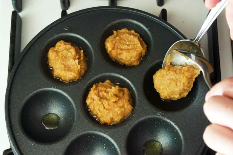 Adding fritters batter to dimpled pan