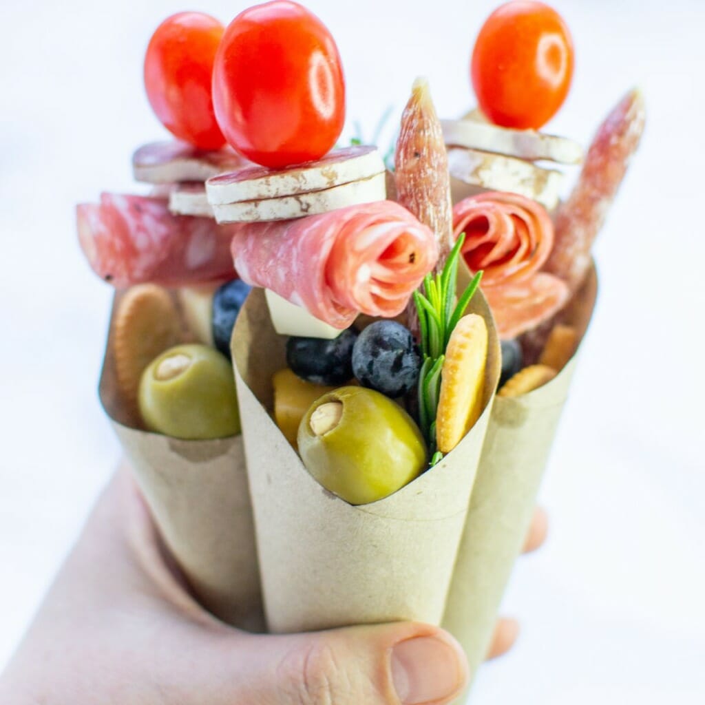 hand holding 3 charcuterie cones