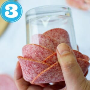 invert glass and use hand to prevent salami from falling out