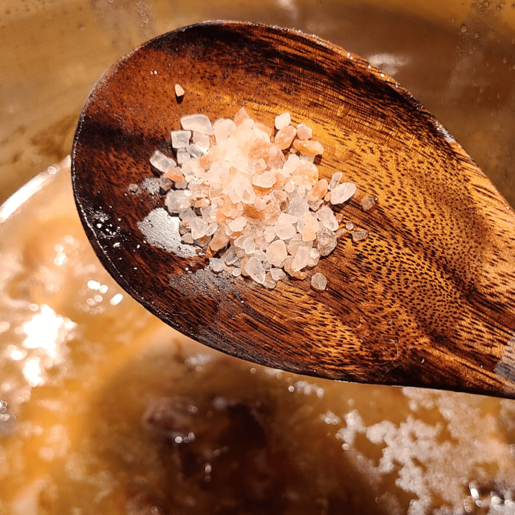 himalayan sea salt on a wooden spoon for bone broth