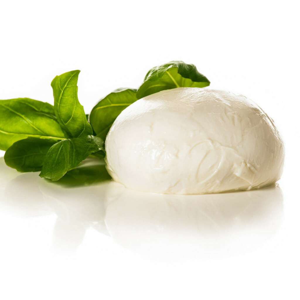 a ball of mozzarella cheese garnished with basil
