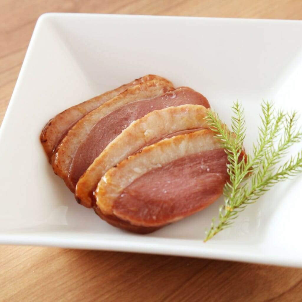 sliced duck breast in a white bowl - charcuterie no pork choice