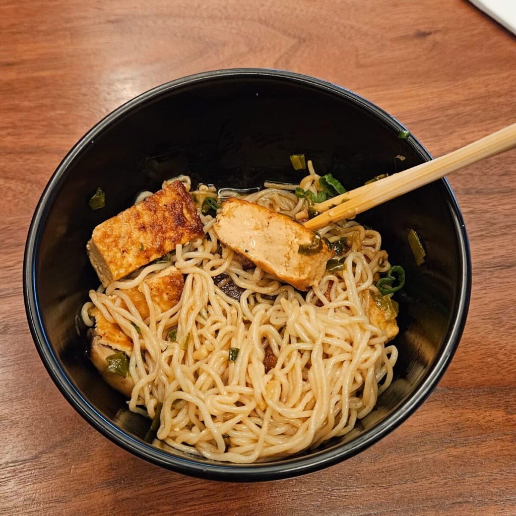 tofu over a bowl of noodle 