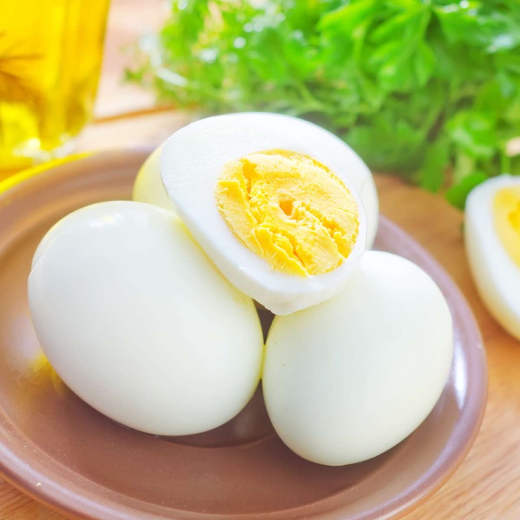 Boiled eggs in plate placed on the table 