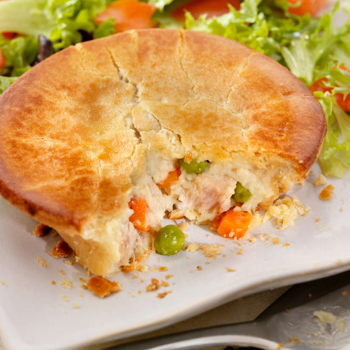 Chicken Pot Pie on the table in front of vegetables