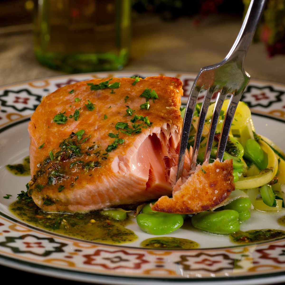 Grilled salmon with lemons, chilis and chimichurri sauce on a plate