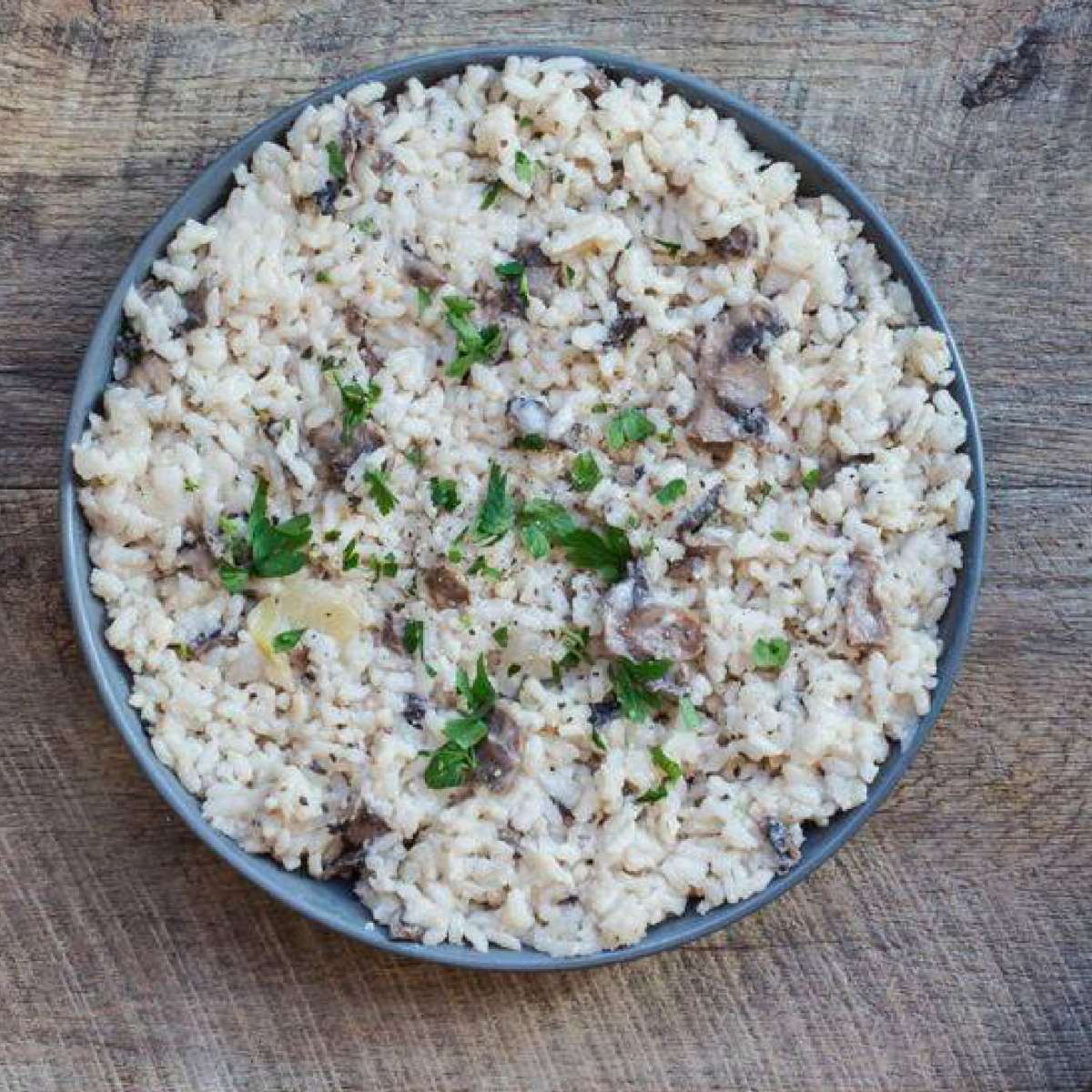 Risotto bowl topped with mint placed on a table