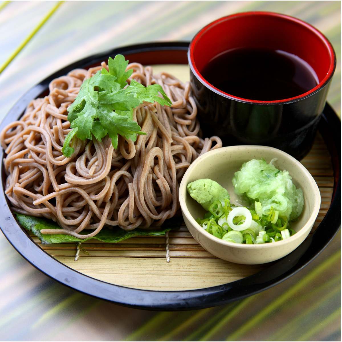 Soba Noodles Topped with Lettuce and soya sauce bowl with salad in a plate placed on  a table 