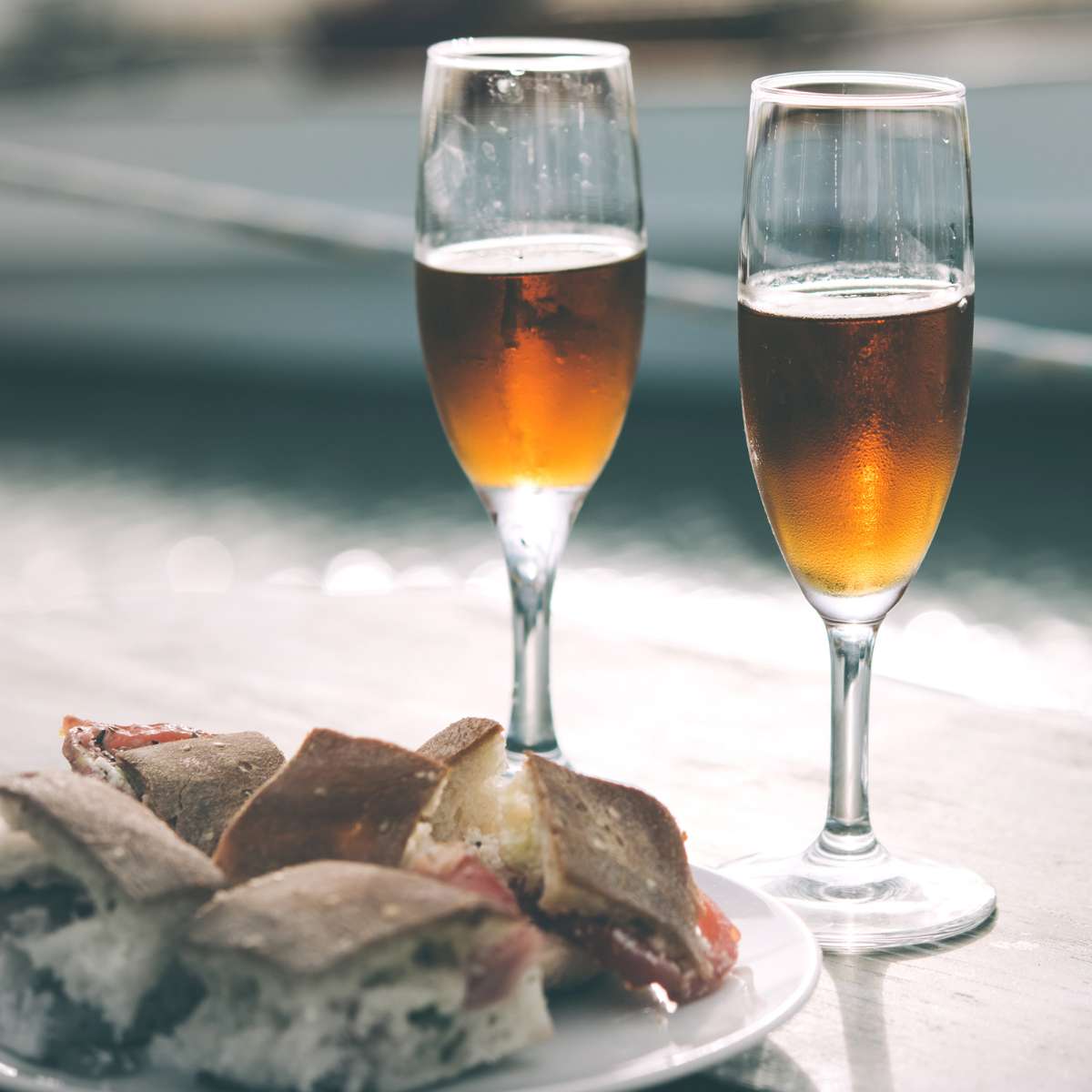 Wine glasses with sandwiches on a plate, elegantly arranged on a table
