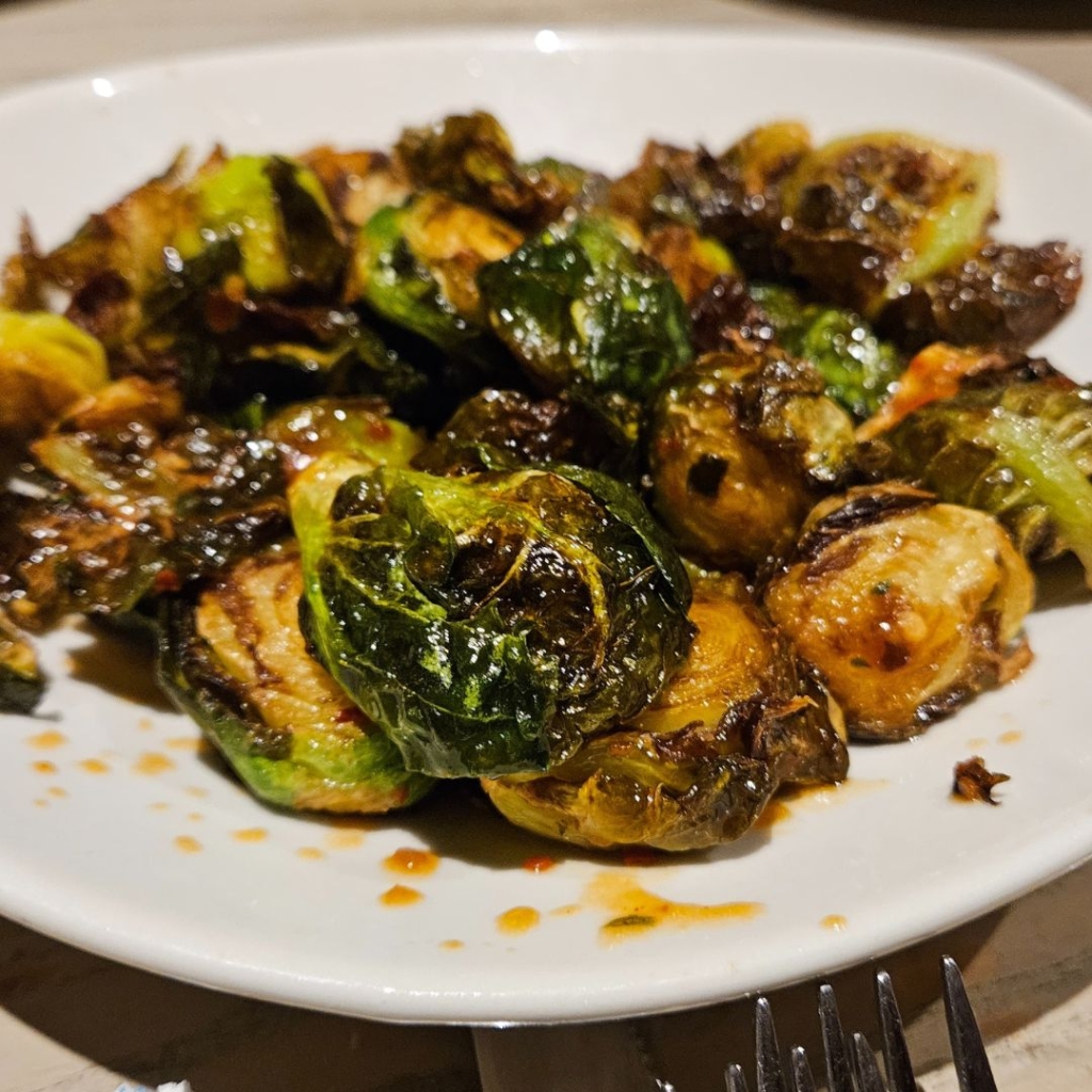 a dish of brussel sprouts with bacon