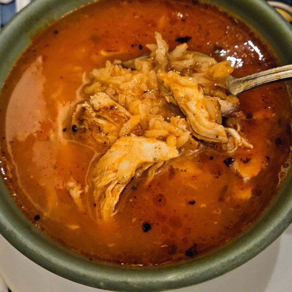 mexican chicken and rice soup tomato broth based, top view 